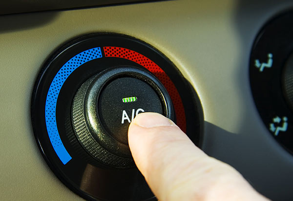 person pressing car ac and heating button