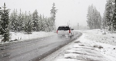 car driving on snowy winter road